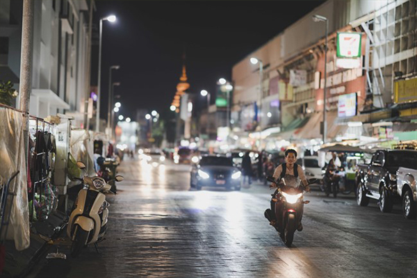 Moped on a city street at night