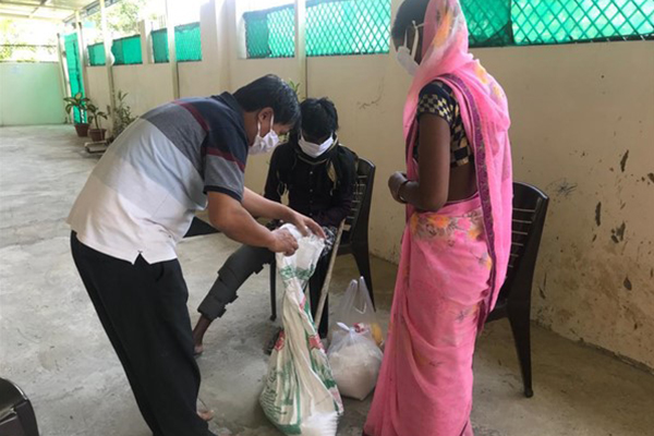 Man giving bag of food away