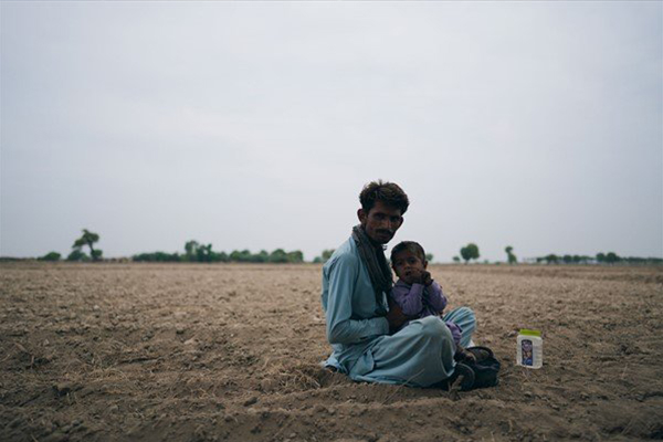 Man and child in field