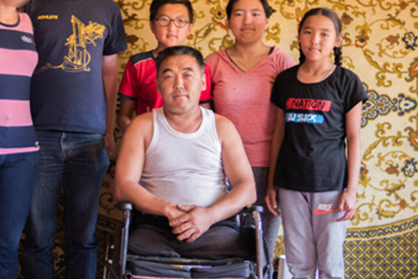 Man in wheelchair with family