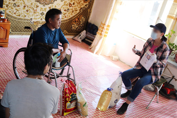 Man in wheelchair listening to a woman